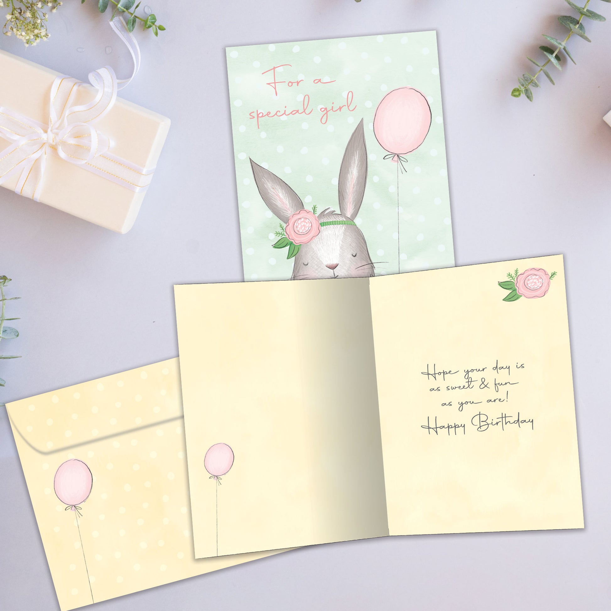 Front and inside view of a Birthday greeting card showcasing a birthday bunny and the words "For a special girl" in soft colors, with a matching envelope.