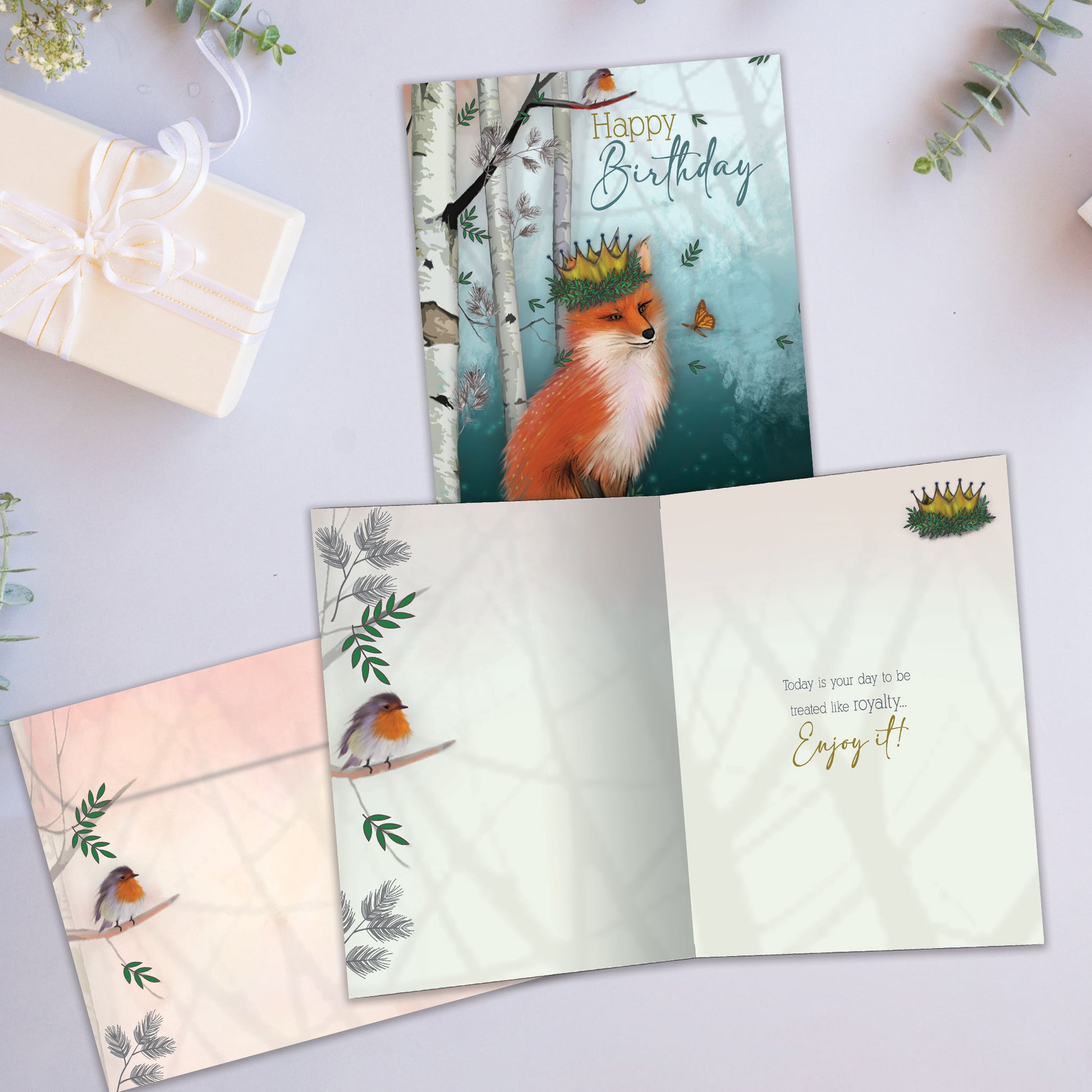 Front and inside view of a Birthday greeting card showcasing a fox wearing a crown in a serene, soft forest background, with a matching envelope.