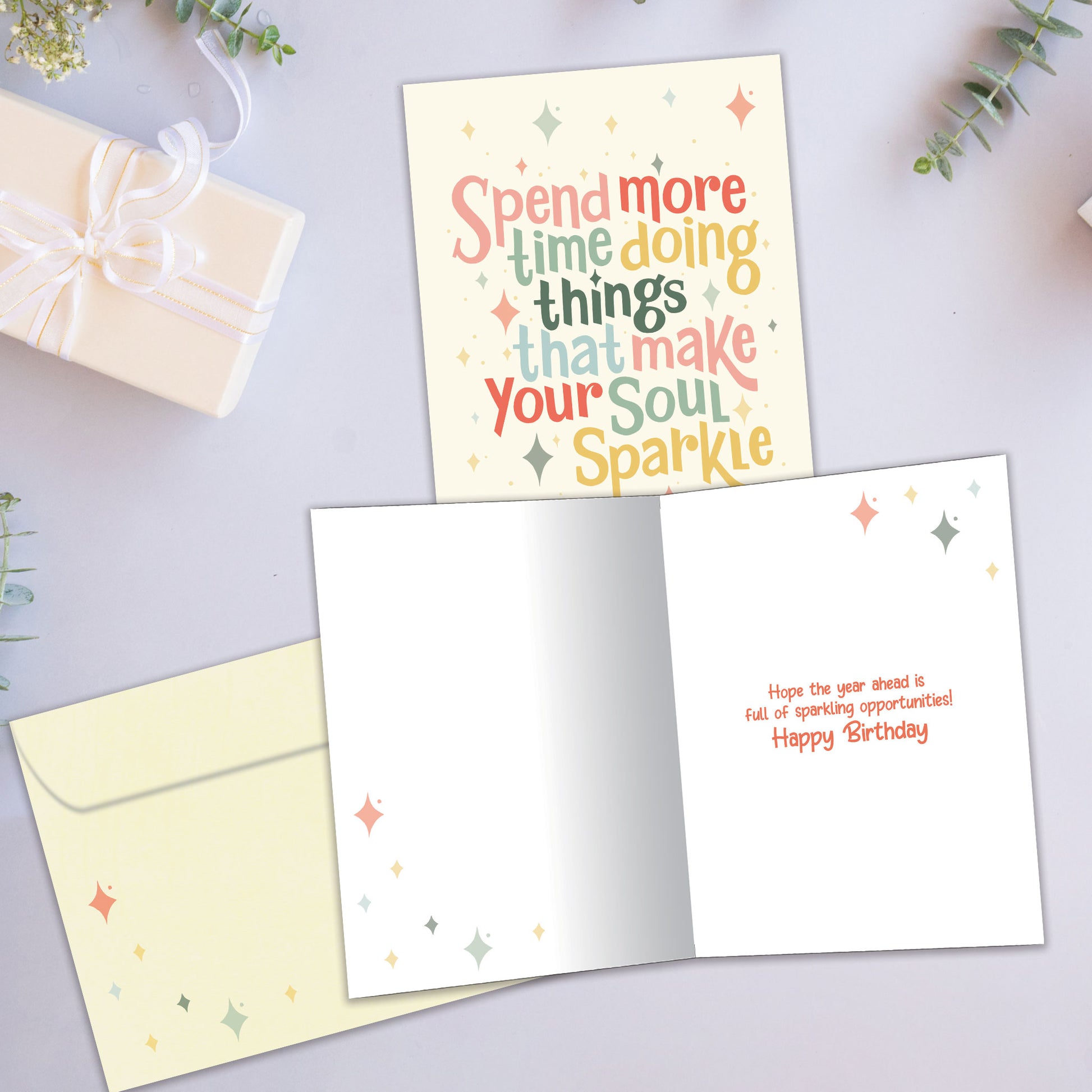 Front and inside view of a Birthday greeting card showcasing the message "spend more time doing things that make your soul sparkle" on a light yellow background, with a matching envelope.