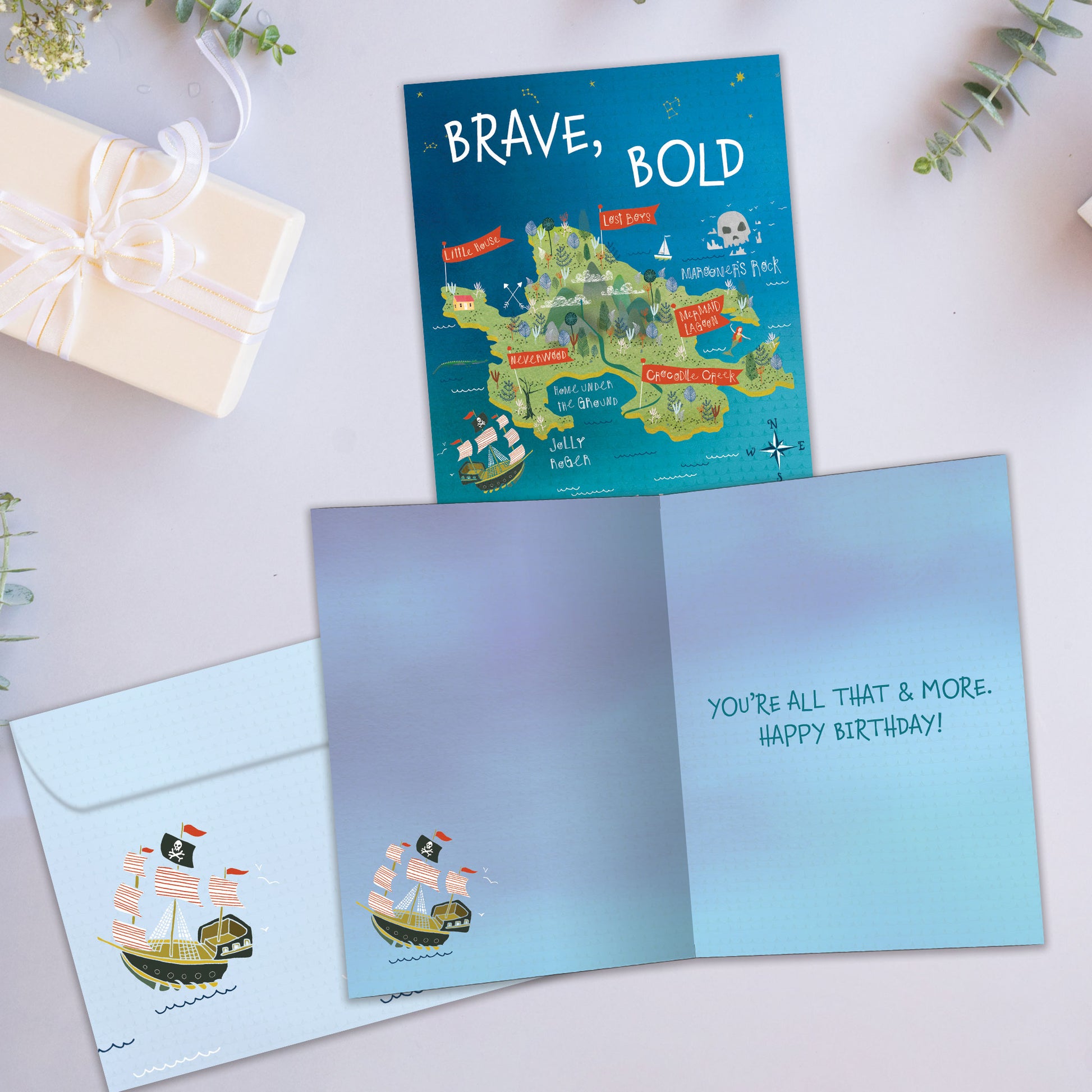 Front and inside view of a Birthday greeting card showcasing a pirate’s map with the words "brave, bold & daring", with a matching envelope.