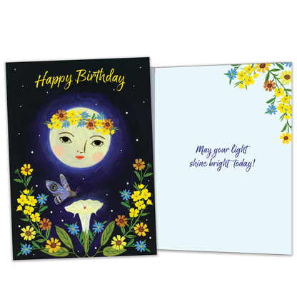Front and inside view of a Birthday greeting card featuring a moon, flowers, and the message "Happy Birthday", with matching design details inside.