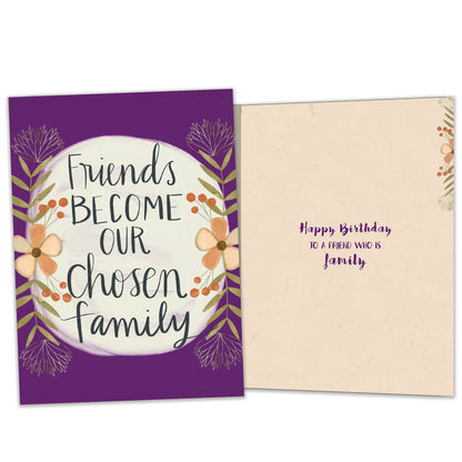 Front and inside view of a birthday greeting card featuring the message "friends become our chosen family" surrounded by flowers on a purple background, with matching design details inside.