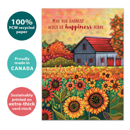 Front view of a birthday greeting card with an illustration of a barn and sunflowers in brilliant autumn colours and a heartfelt message, highlighting its eco-friendly materials and made in Canada.