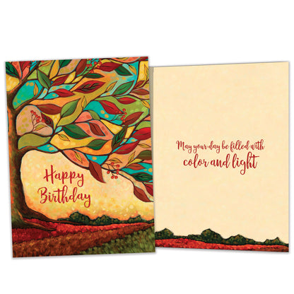 Front and inside view of a birthday greeting card featuring the message "happy birthday" surrounded by a tree and vibrant fall colours, with matching design details inside.