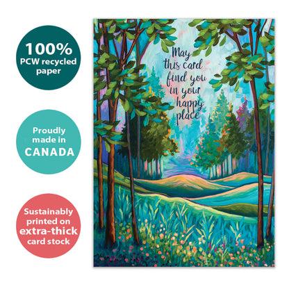 Front view of a birthday greeting card with an illustration of a tranquil forest and a message about finding your happy place, highlighting its eco-friendly materials and made in Canada.