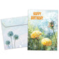 Front view of a birthday greeting card featuring an illustration of dandelions in soft colours with the message "happy birthday", with a matching envelope.