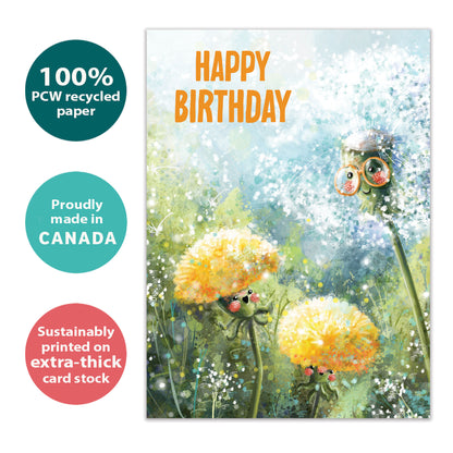 Front view of a birthday greeting card with an illustration of dandelions in soft colours and the message "happy birthday", highlighting its eco-friendly materials and made in Canada.