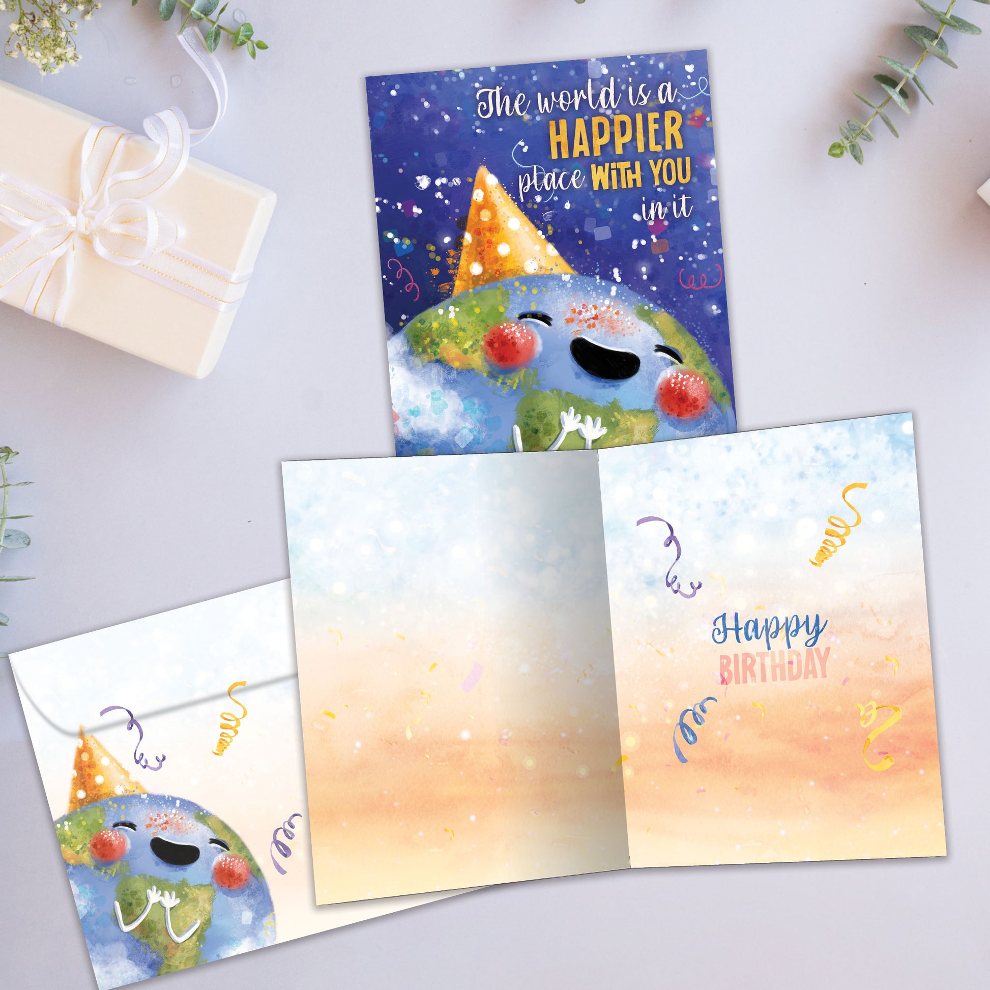 Front and inside view of a birthday greeting card showcasing an illustration of the earth with a happy face and a party hat, with a message about you making the world a happier place, with a matching envelope.