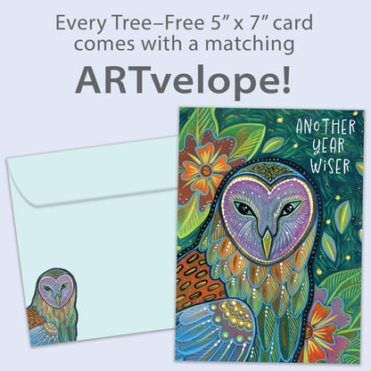 Front view of a birthday greeting card featuring an artistic and colourful illustration of an owl and foliage with the message "another year wiser", with matching envelope artwork.