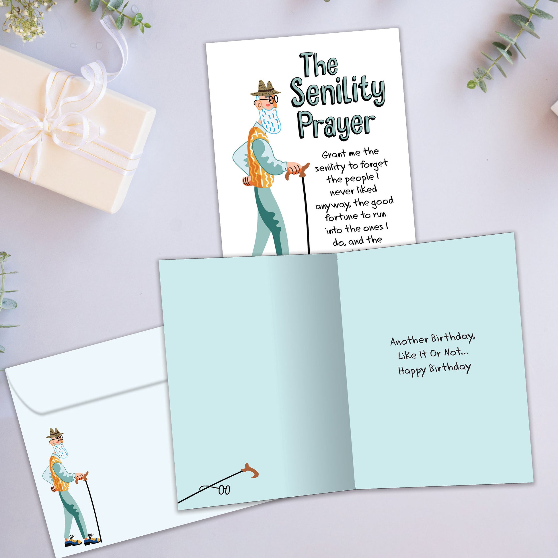 Front and inside view of a Birthday greeting card showcasing an elderly man with a cane and the Senility Prayer, with a matching envelope.