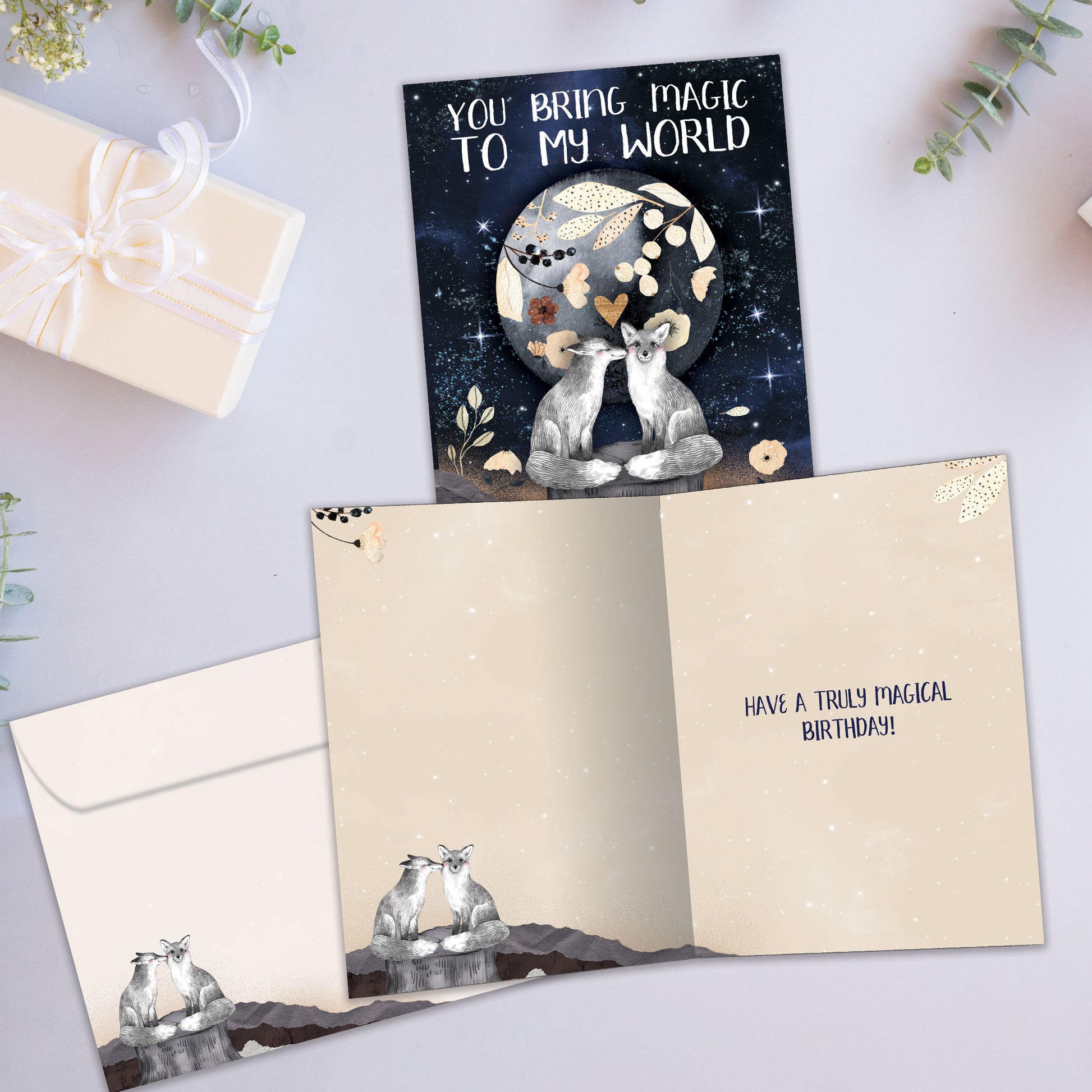 Front and inside view of a Birthday greeting card showcasing two endearing foxes and a sentimental message, with a matching envelope.