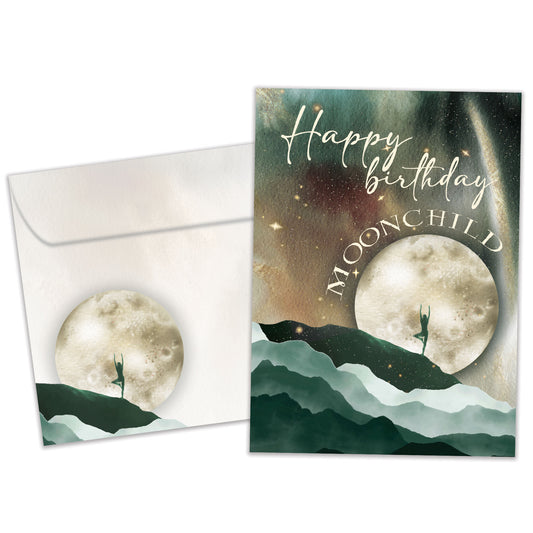 Front view of a Birthday greeting card featuring a moon and mountains scene with the message "Happy Birthday Moonchild", and a matching envelope