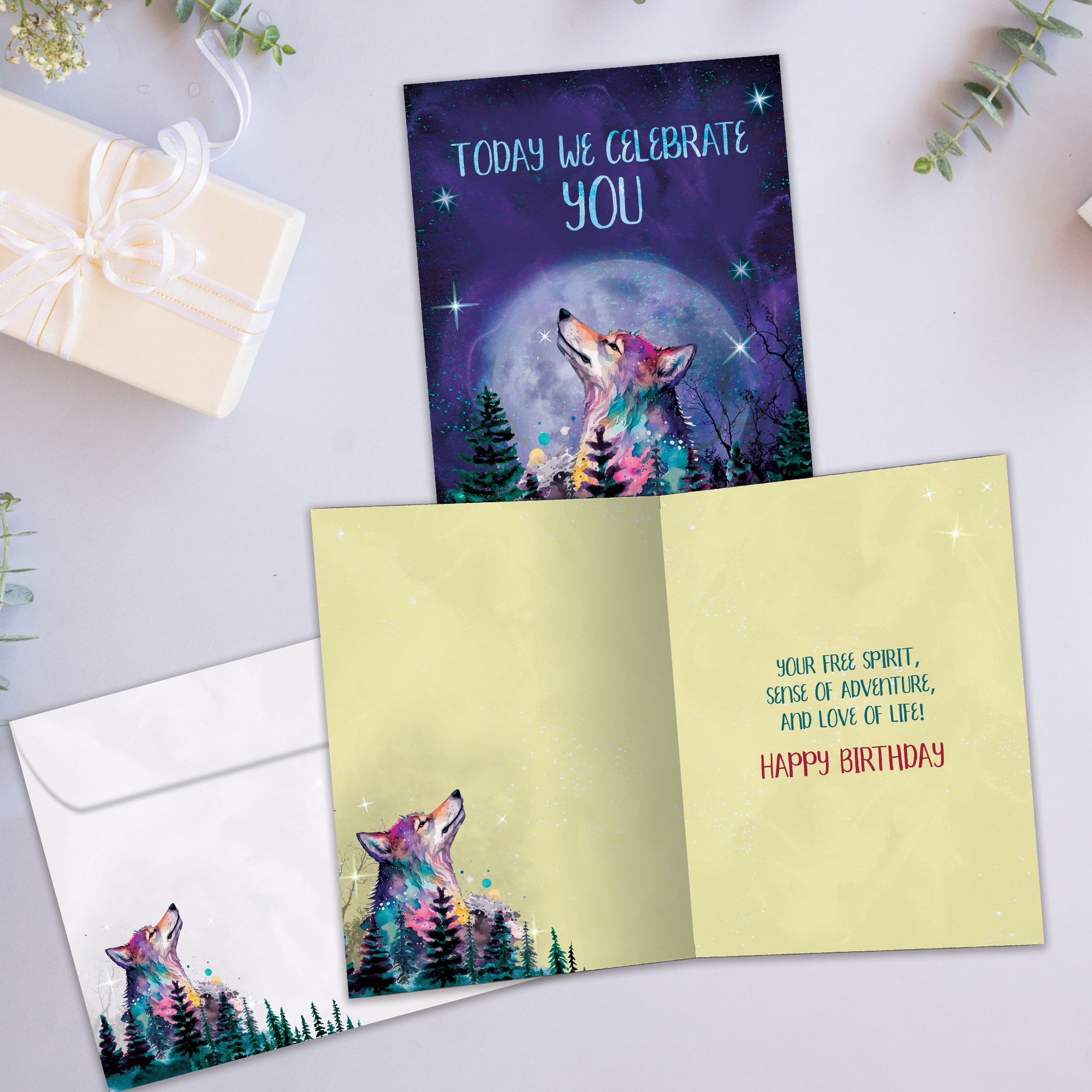 Front and inside view of a Birthday greeting card showcasing a wolf in a forest and moon in the background with a message, with a matching envelope