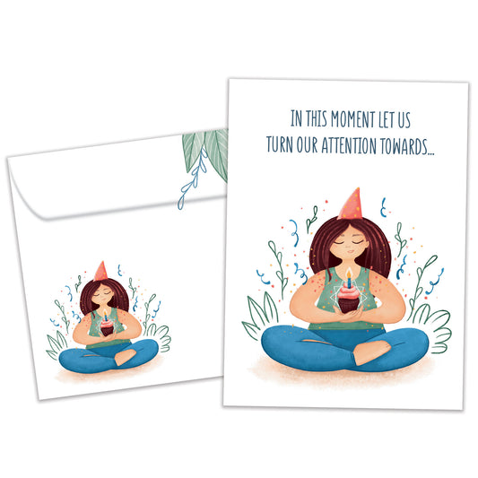Front view of a Birthday greeting card featuring a woman meditating and holding a cupcake and a message, with a matching envelope.