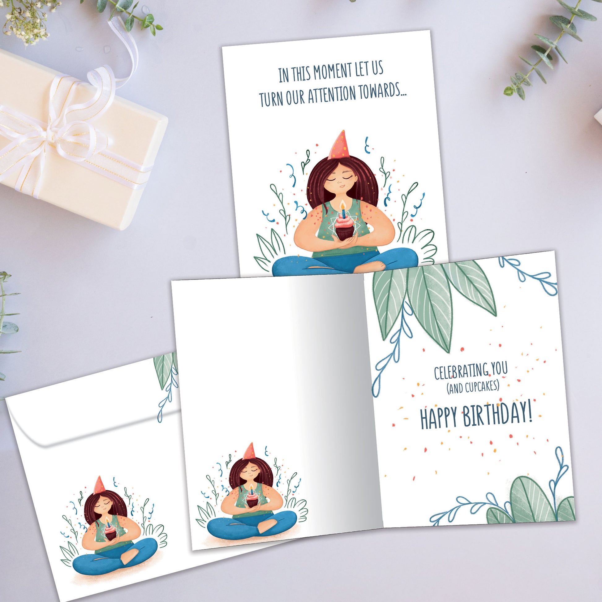Front and inside view of a Birthday greeting card showcasing a woman meditating and holding a cupcake and a message, with a matching envelope.