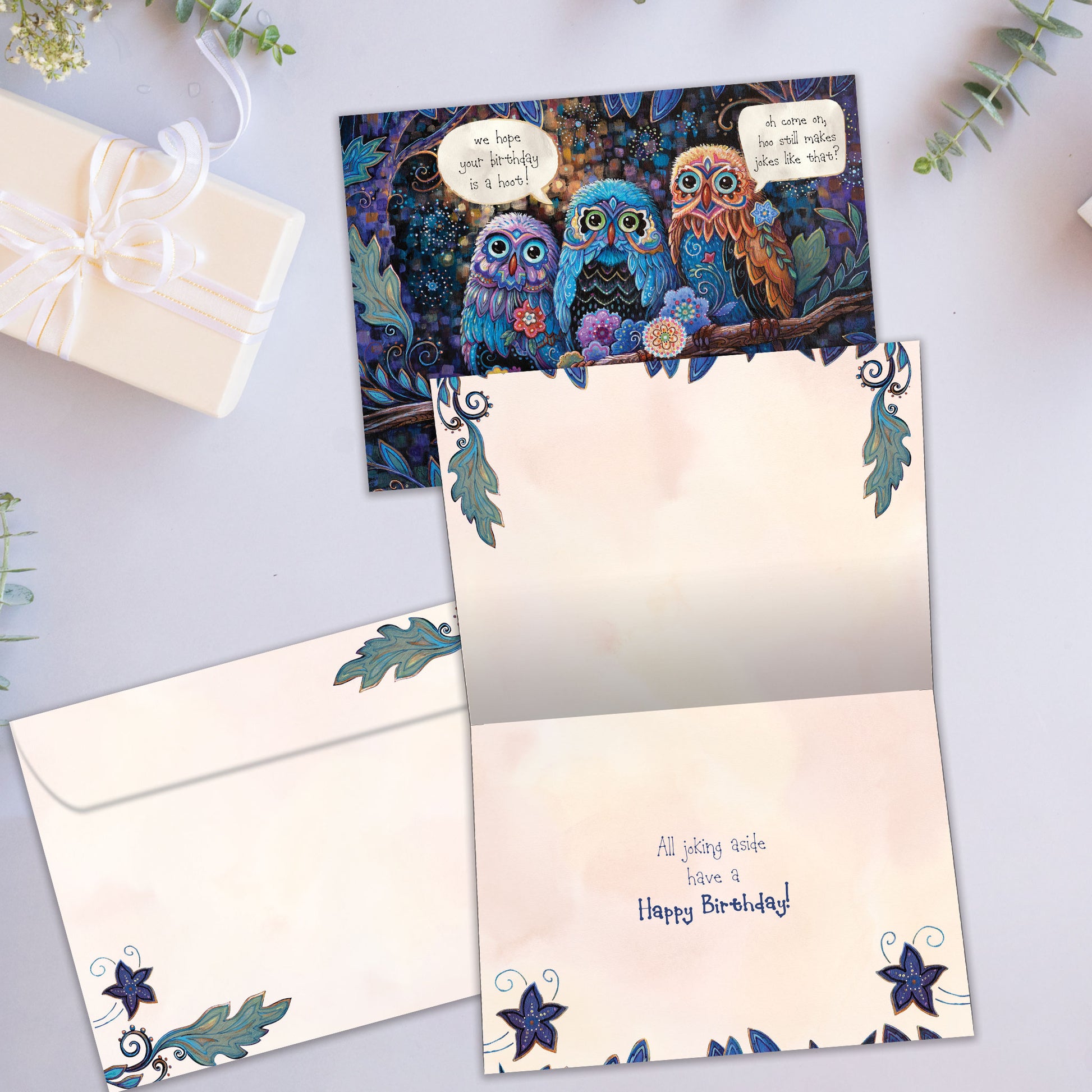 Front and inside view of a Birthday greeting card showcasing a colorful illustration of owls and a birthday message, with a matching envelope.