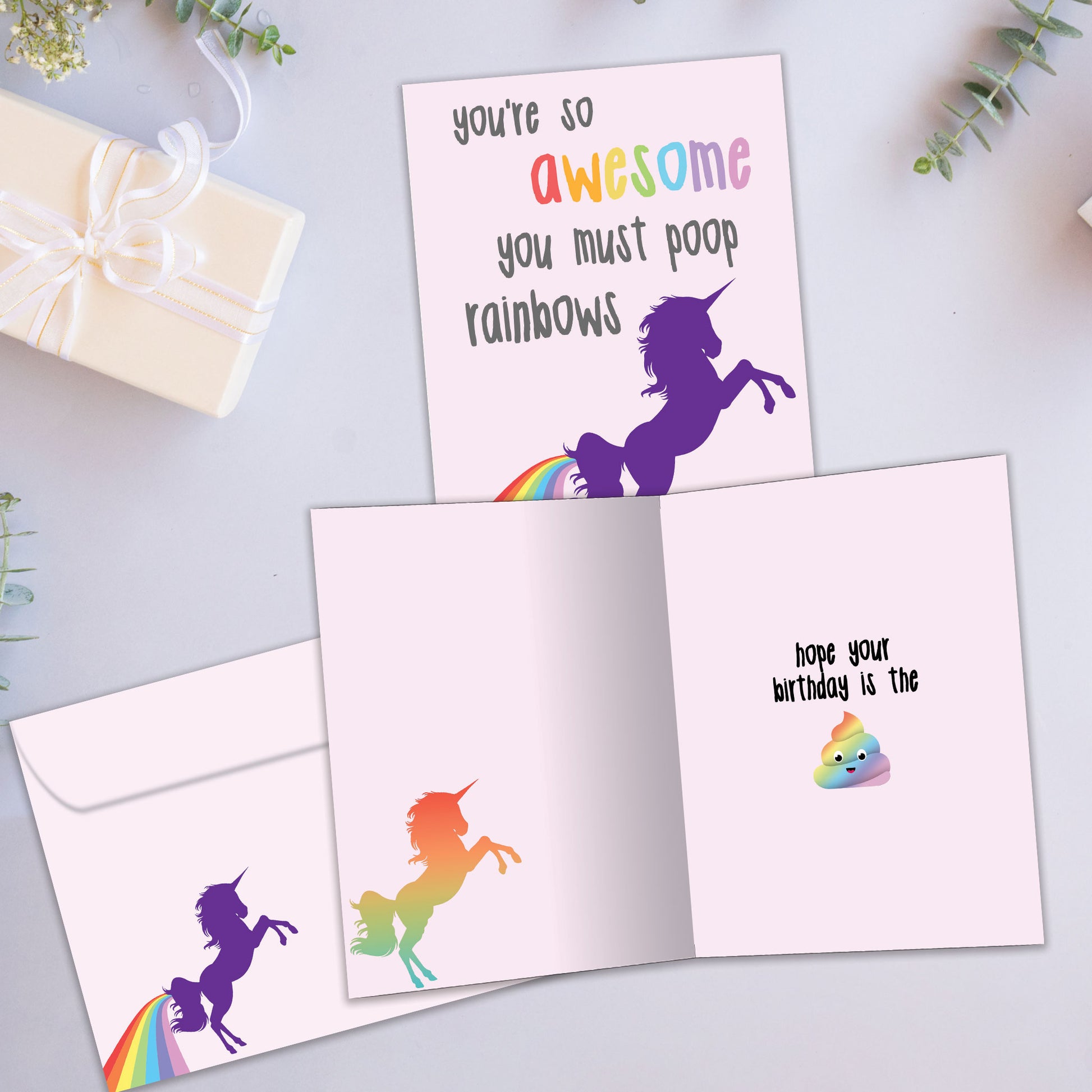 Front and inside view of a Birthday greeting card showcasing a colorful unicorn with a message about being awesome, with a matching envelope