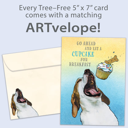 Front view of a Birthday greeting card featuring a playful image of a dog eating a cupcake and a fun message, with matching envelope artwork.