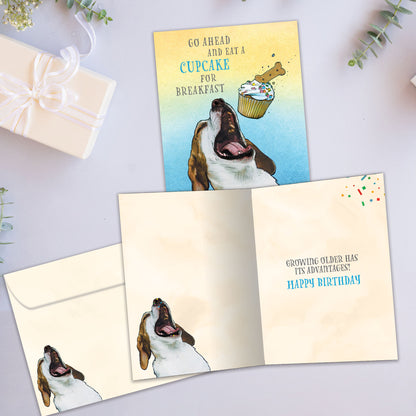 Front and inside view of a Birthday greeting card showcasing a playful image of a dog eating a cupcake and a fun message, with a matching envelope