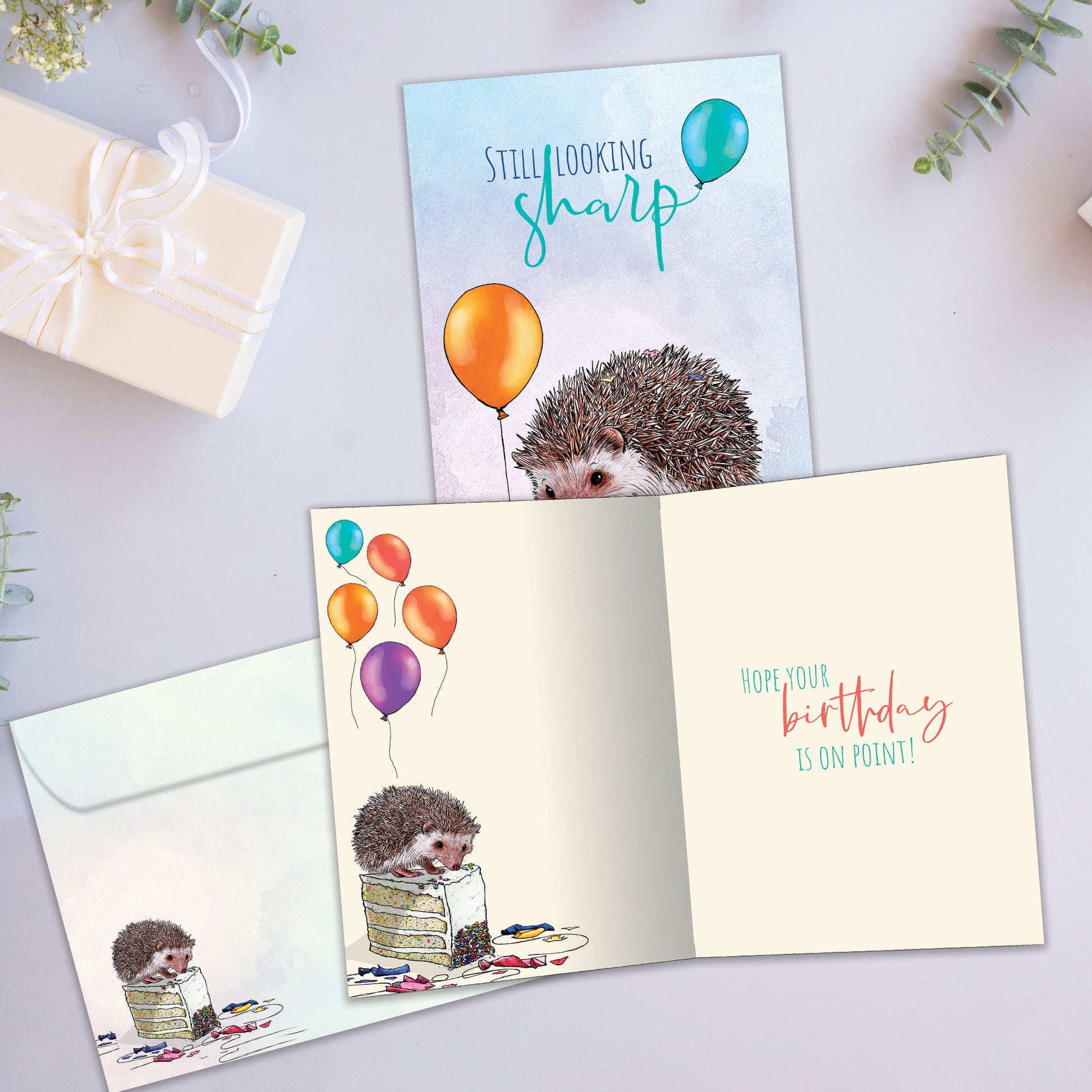 Front and inside view of a Birthday greeting card showcasing a porcupine with the message "Still looking sharp", with a matching envelope