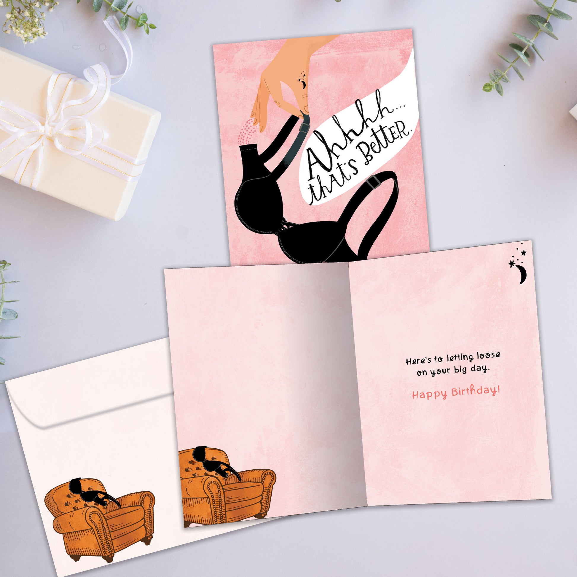 Front and inside view of a Birthday greeting card featuring a hand holding a bra with the message "Ahhhh…that’s better", with a matching envelope