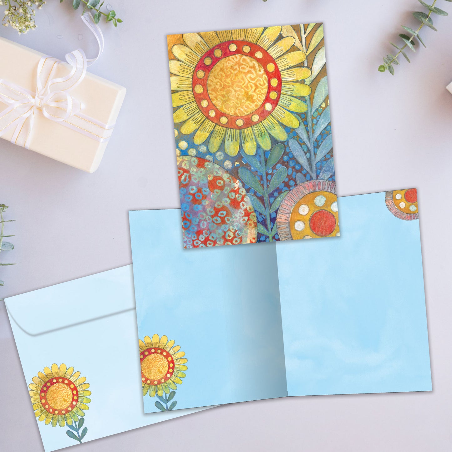 Front and inside view of an All Occasion greeting card with a large sunflower illustration, plus matching envelope design.