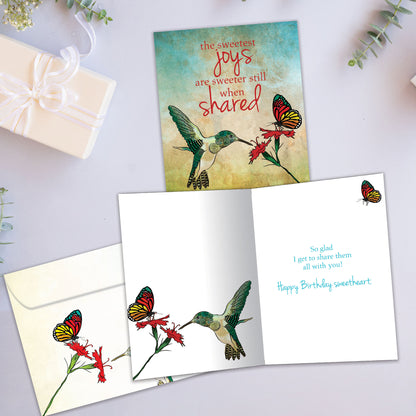 Front and inside view of a Birthday greeting card showcasing a flower, humming bird and butterfly and sweet message, with a matching envelope.