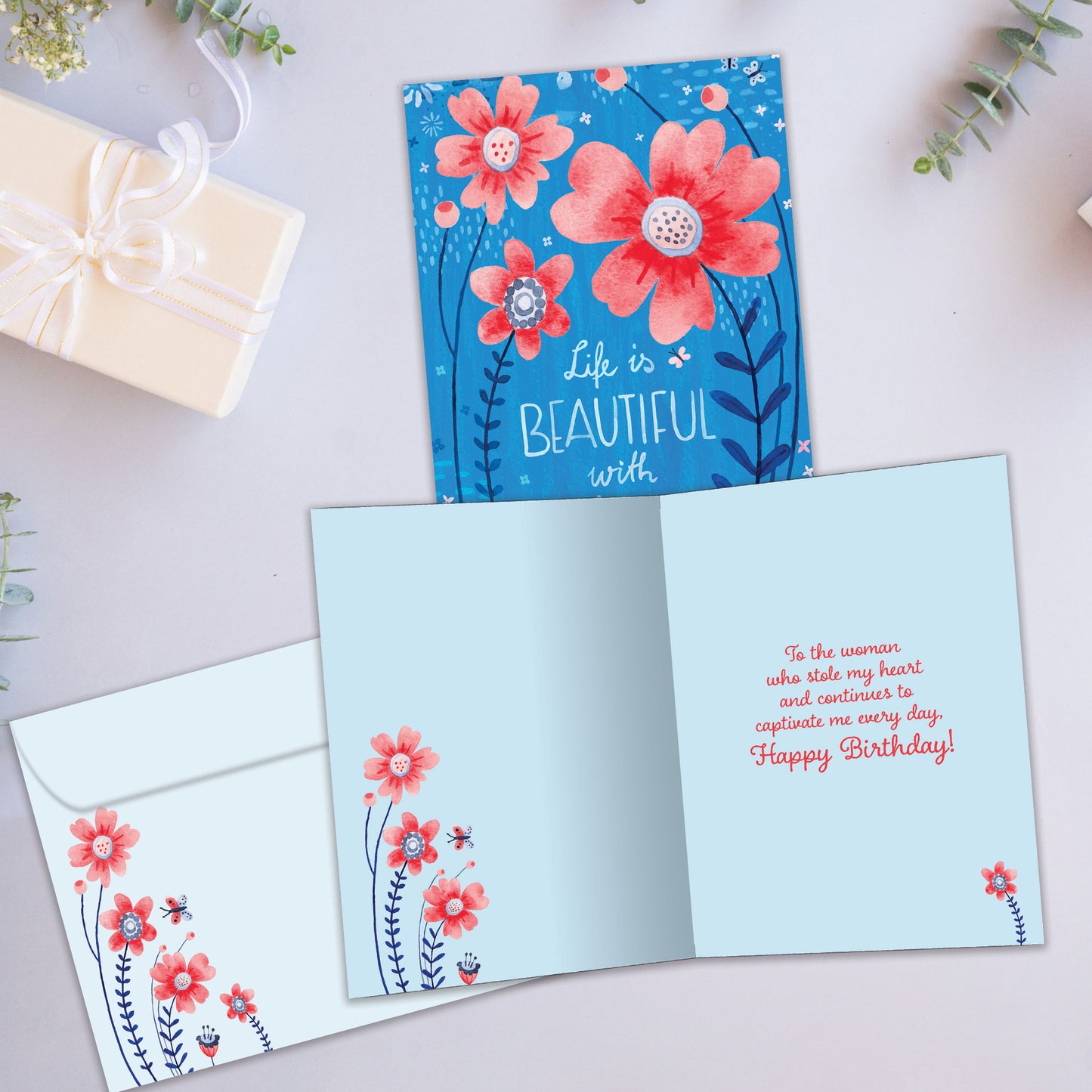 Front and inside view of a Birthday greeting card showcasing a beautiful floral design and the message "Life is beautiful with you", with a matching envelope