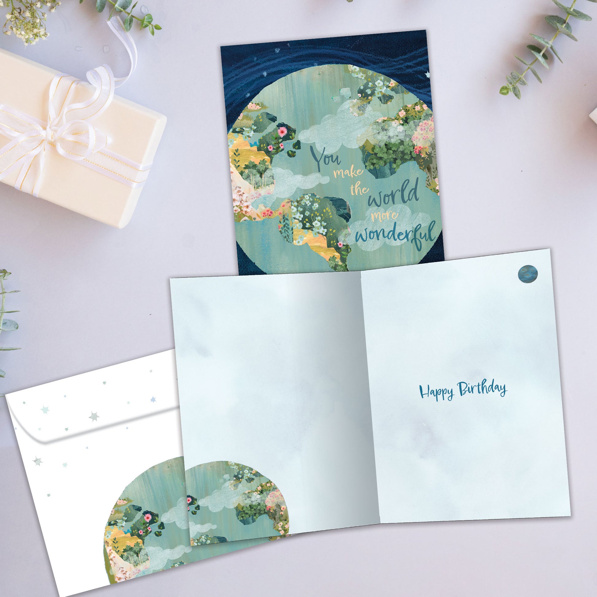 Front and inside view of a Birthday greeting card showcasing a colourful globe with a complimentary message, with a matching envelope.