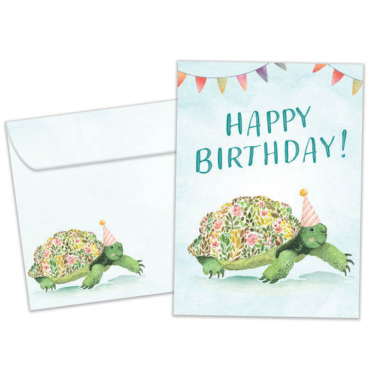 Front view of a Birthday greeting card featuring a flowery turtle with the message "Happy Birthday", with a matching envelope