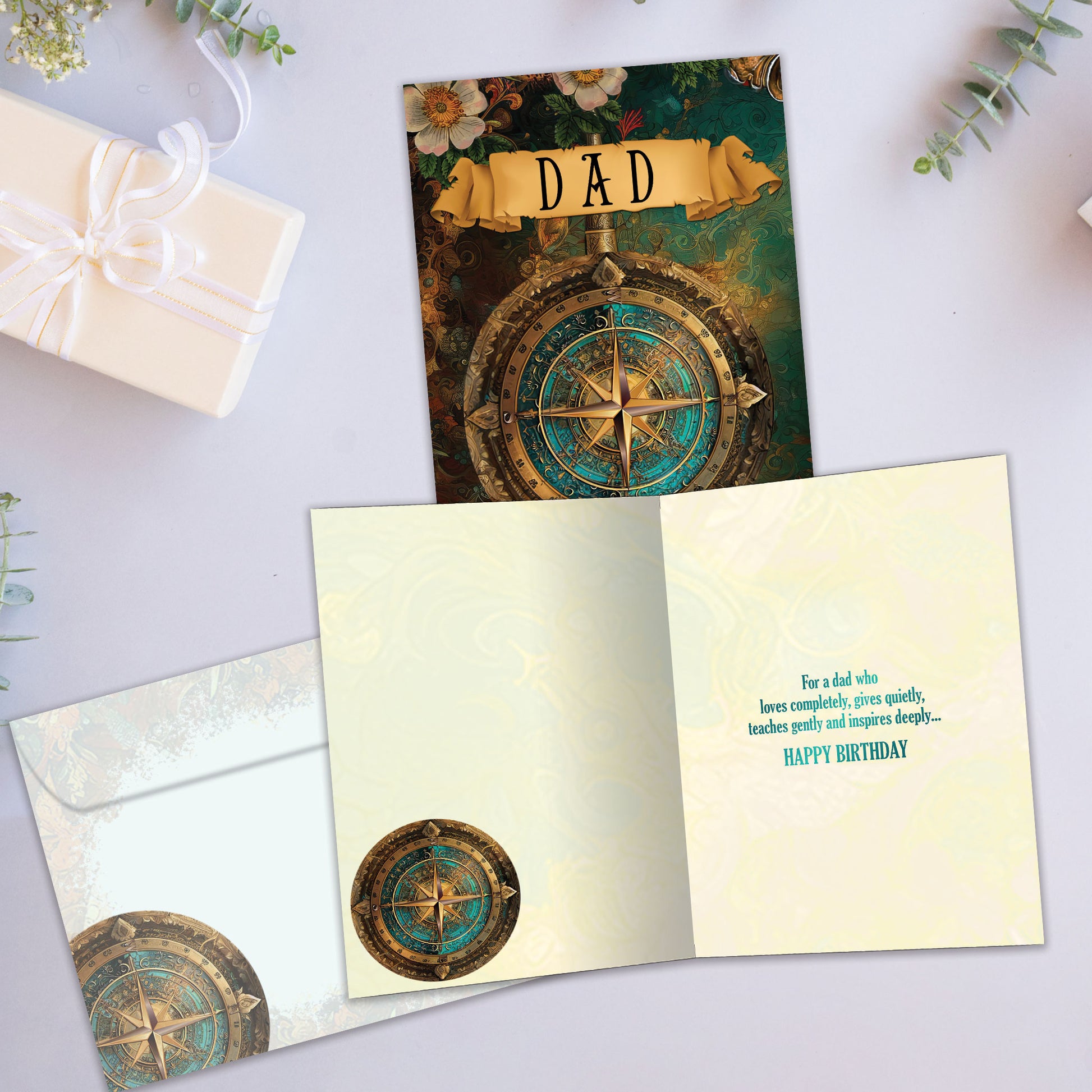 Front and inside view of a Birthday greeting card showcasing a beautifully coloured compass and the word "Dad", with a matching envelope