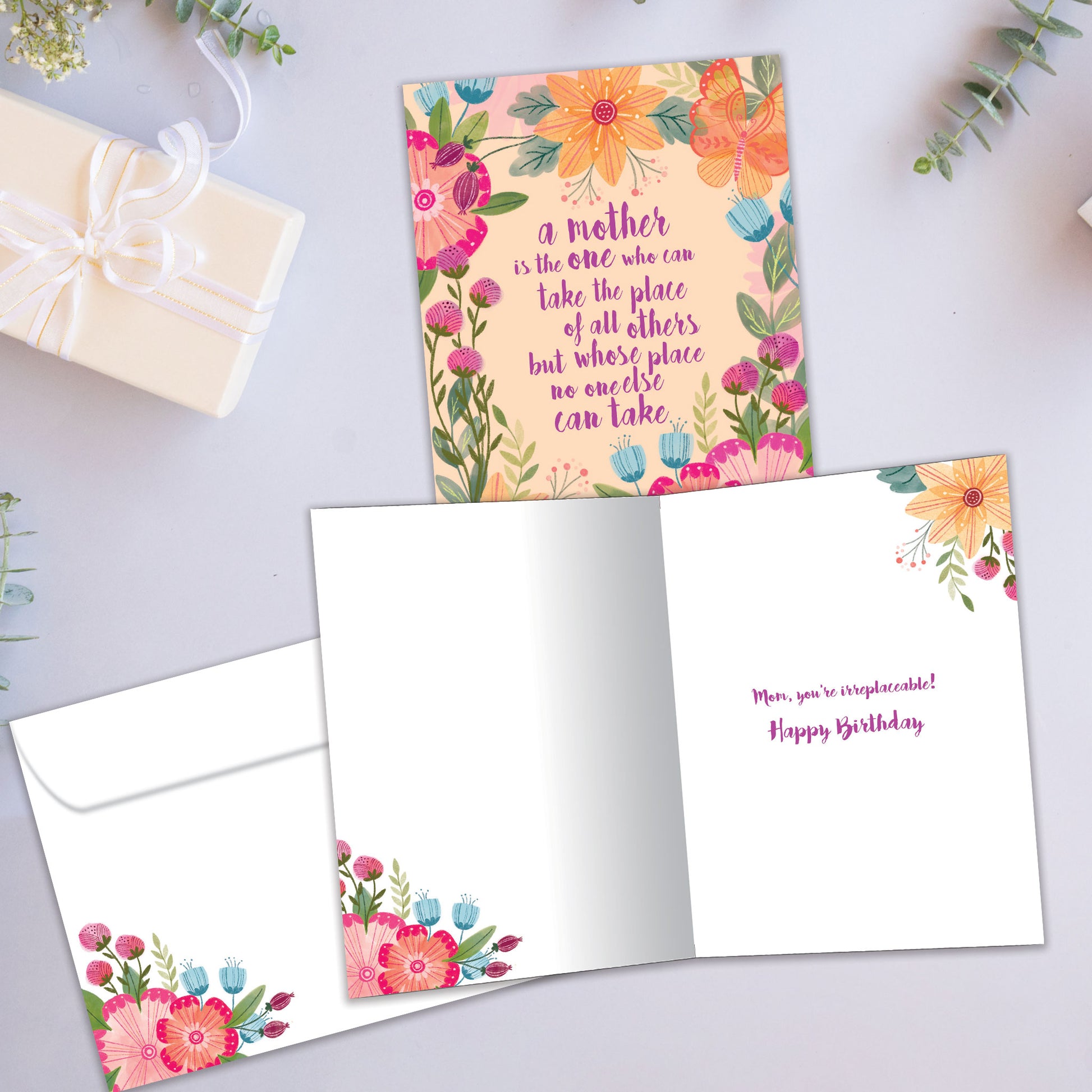 Front and inside view of a Birthday greeting card featuring a floral design surrounding an endearing message about mothers, with a matching envelope.