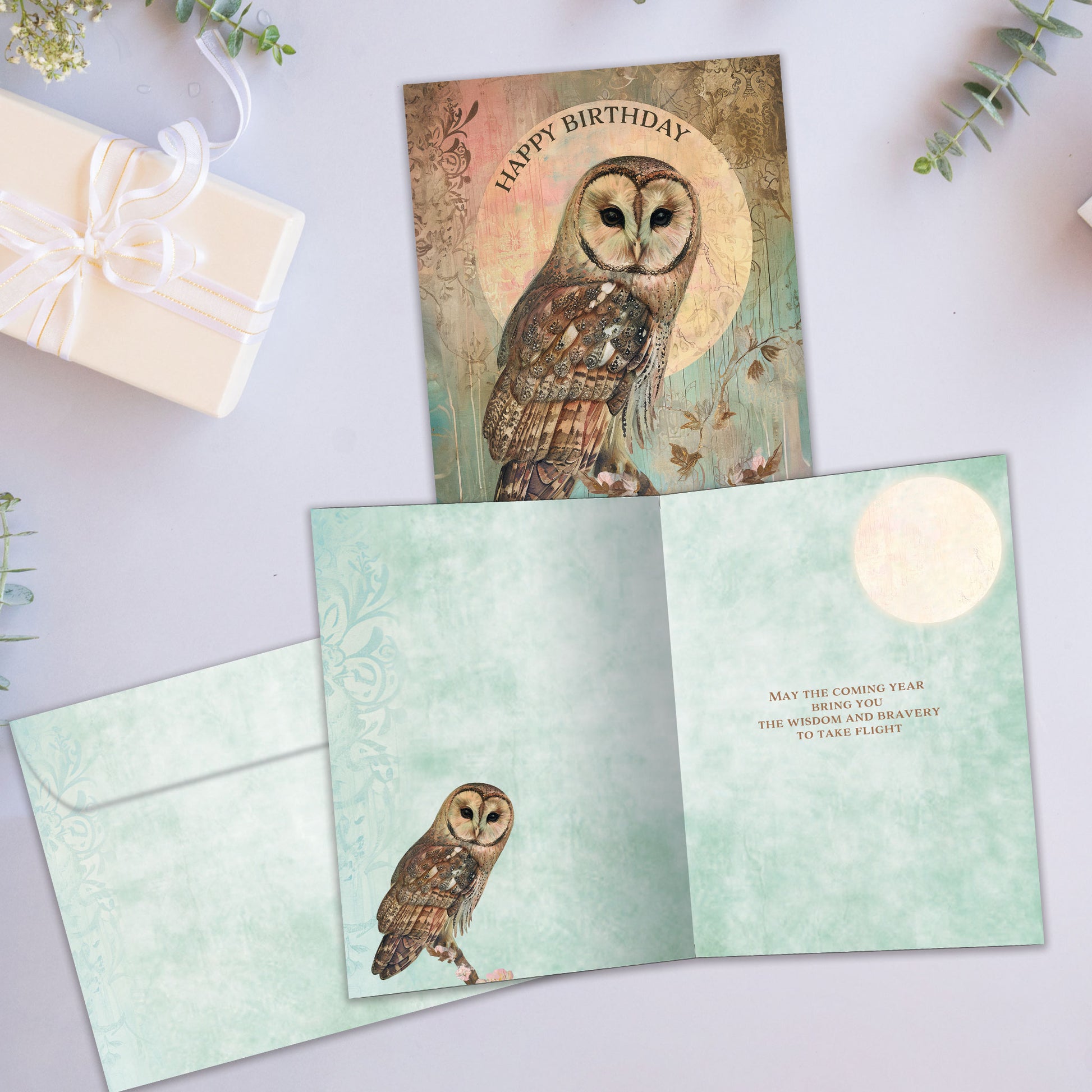 Front and inside view of a Birthday greeting card showcasing and illustration of an owl with the message "Happy Birthday", with a matching envelope.