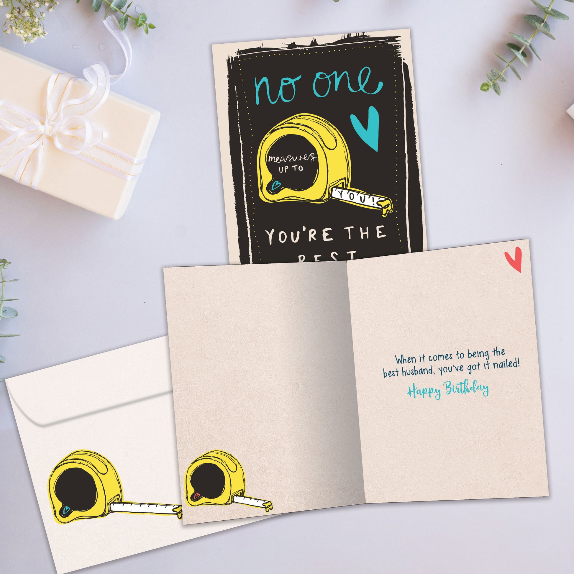 Front and inside view of a Birthday greeting card showcasing an illustration of a tape measure with a message about measuring up, with a matching envelope.