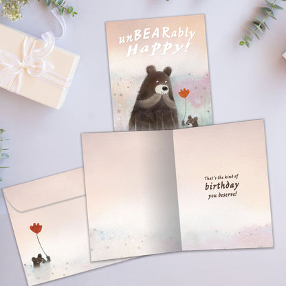 Front and inside view of a Birthday greeting card showcasing an illustration of a cub bear handing a flower to a bear, with a matching envelope.