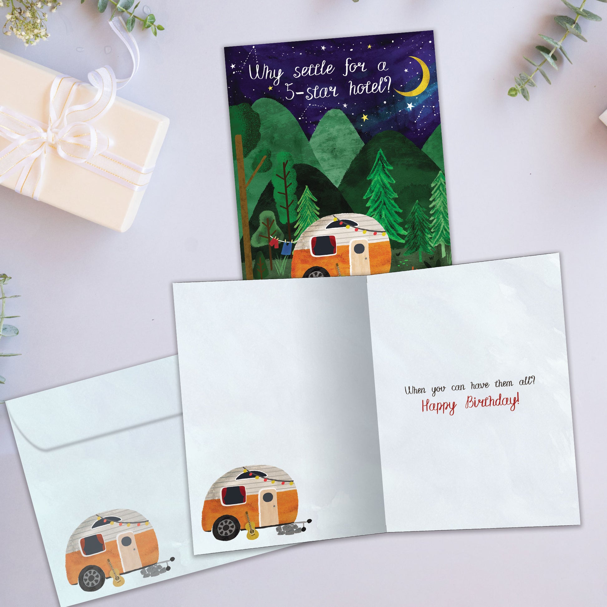 Front and inside view of a Birthday greeting card showcasing an illustration of a camper in the woods at night, with a matching envelope.