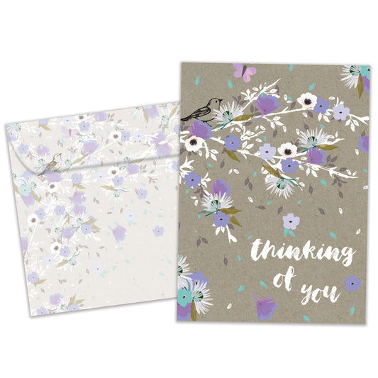 Front view of an All Occasion greeting card and matching envelope featuring purple flowers with the words 'Thinking of You' in a thoughtful, elegant design.