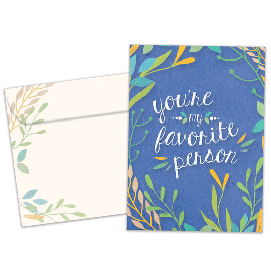 Front view of an All Occasion greeting card and matching envelope featuring the message 'You're my favorite person' surrounded by soft-coloured foliage on a blue background.