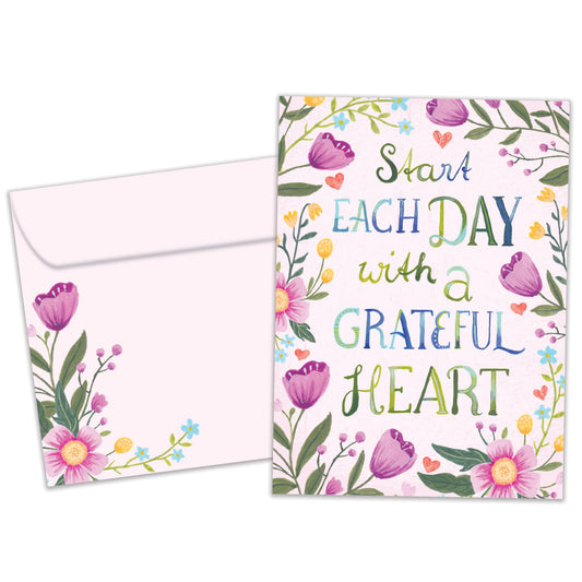 Front view of an All Occasion greeting card and matching envelope with the message 'Start each day with a grateful heart' surrounded by delicate flowers.