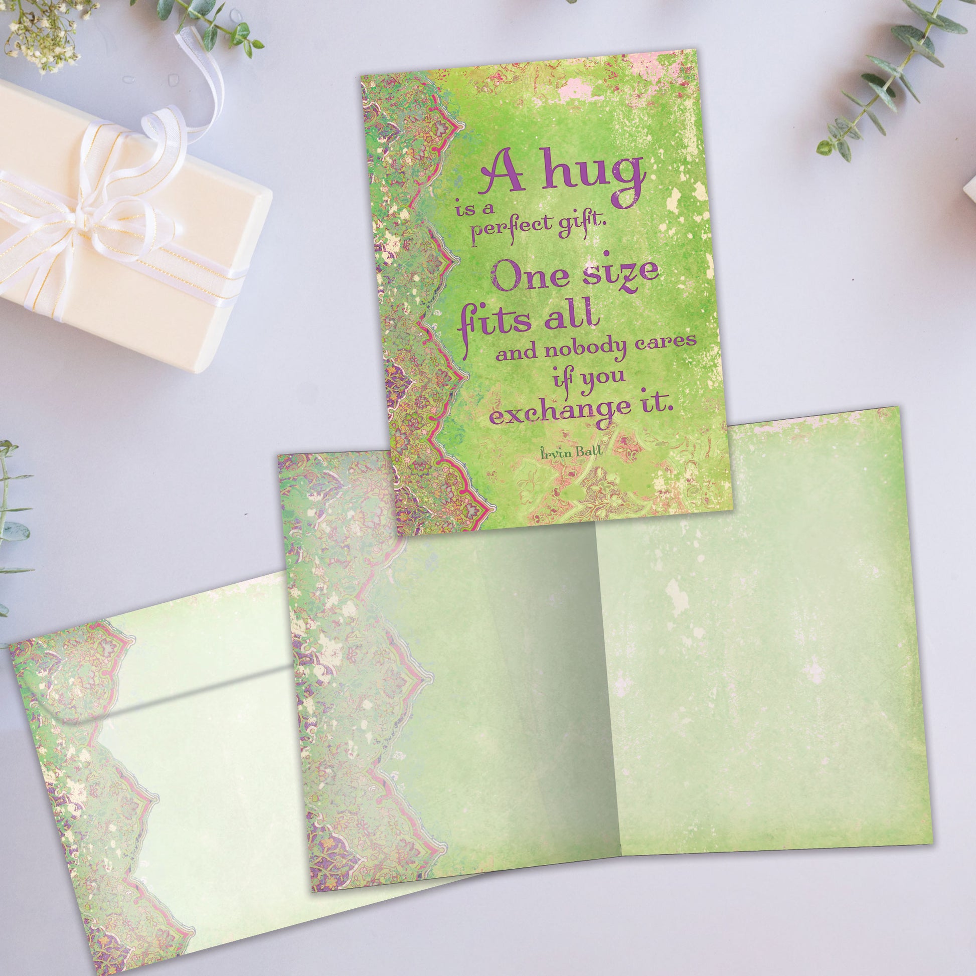 Front and inside view of an All Occasion greeting card showcasing an artistic cover and a warm message about a hug, along with a matching envelope.