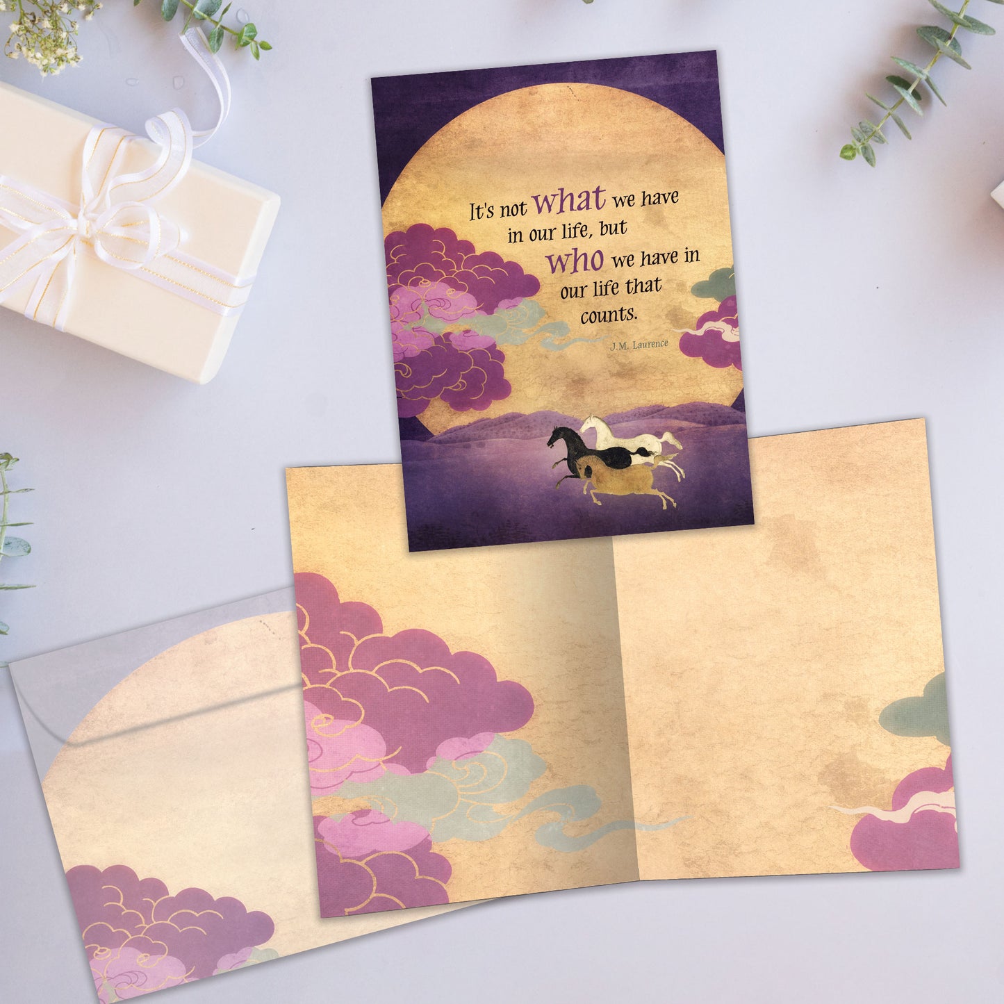 Front and inside view of an All Occasion greeting card showcasing horses running in front of the sun and a heartfelt message about cherishing people, with a matching envelope.