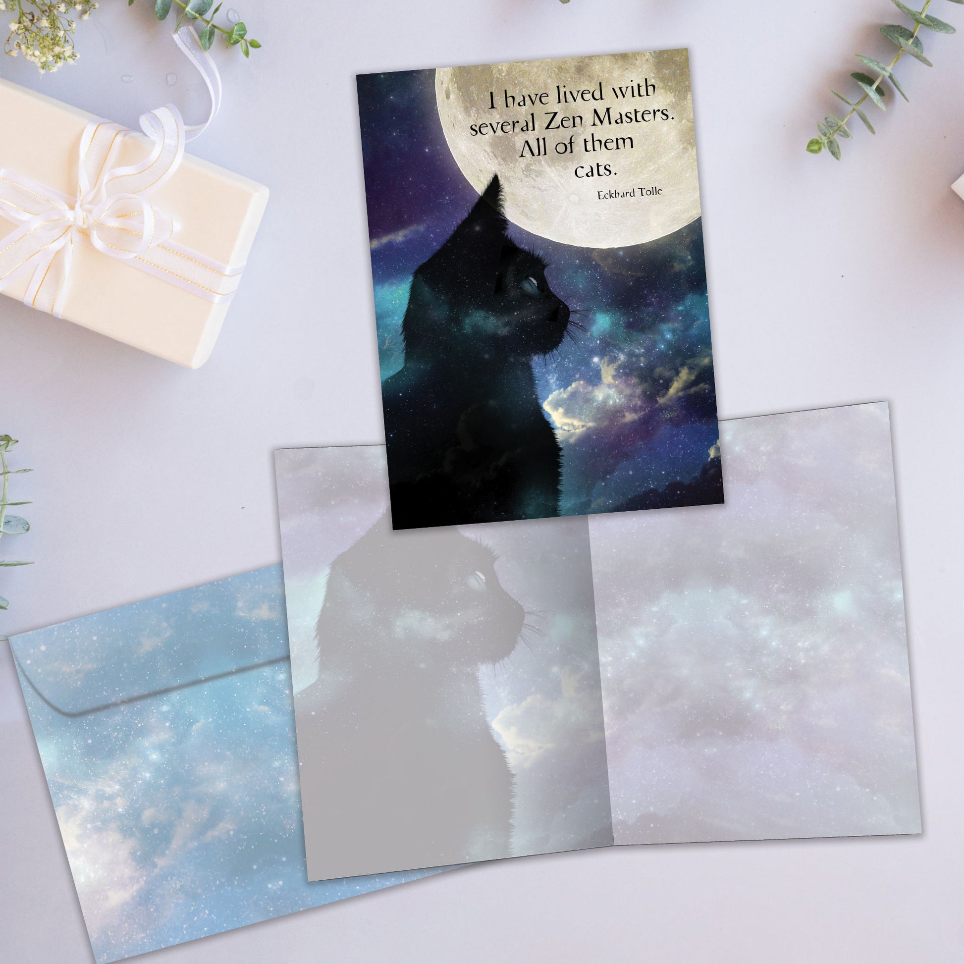 Front and inside view of an All Occasion greeting card showcasing a cat and moon design with a heartfelt quote about cats, along with a matching envelope.