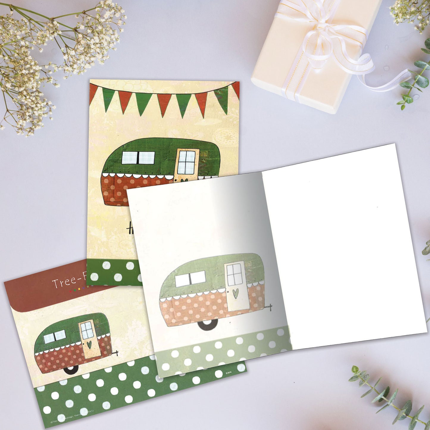 Front and inside view of an All Occasion greeting card showcasing a camper illustration with 'Happy Camper' text, with a matching envelope.