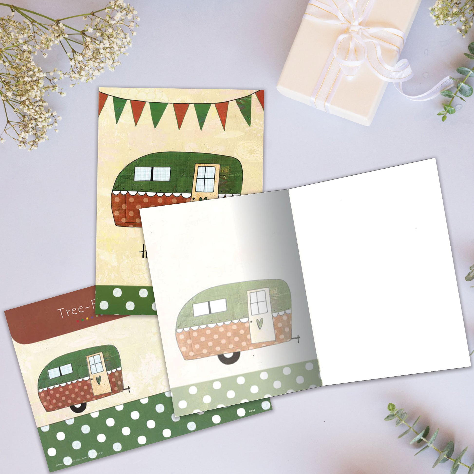 Front and inside view of an All Occasion greeting card showcasing a camper illustration with 'Happy Camper' text, with a matching envelope.