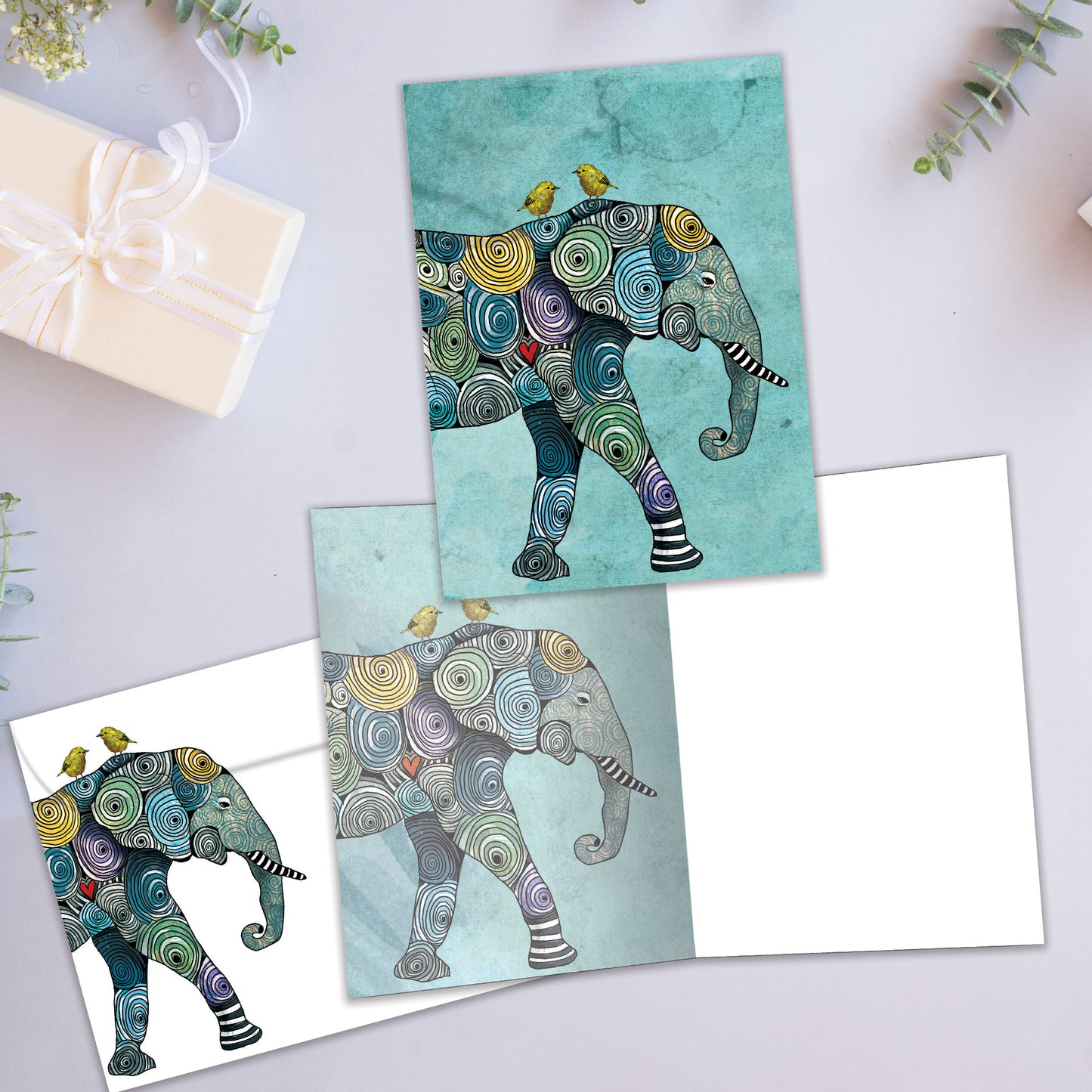 Front and inside view of an All Occasion greeting card showcasing a colourful elephant illustration in a striking design, with a matching envelope.