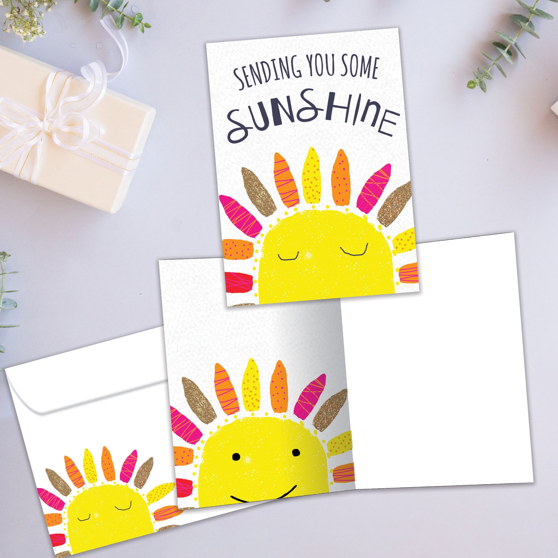 Front and inside view of an All Occasion greeting card showcasing an illustration of a sun with 'Sending You Some Sunshine' text, with a matching envelope.