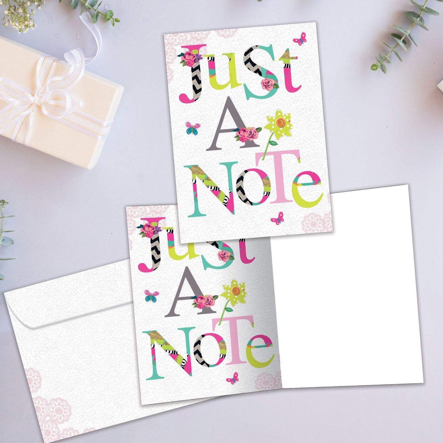 Front and inside view of an All Occasion greeting card showcasing a floral design with 'Just A Note' text, with a matching envelope.