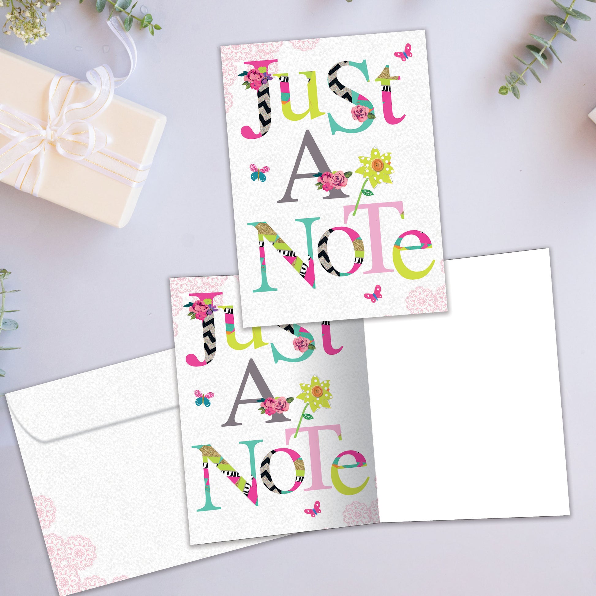 Front and inside view of an All Occasion greeting card showcasing a floral design with 'Just A Note' text, with a matching envelope.