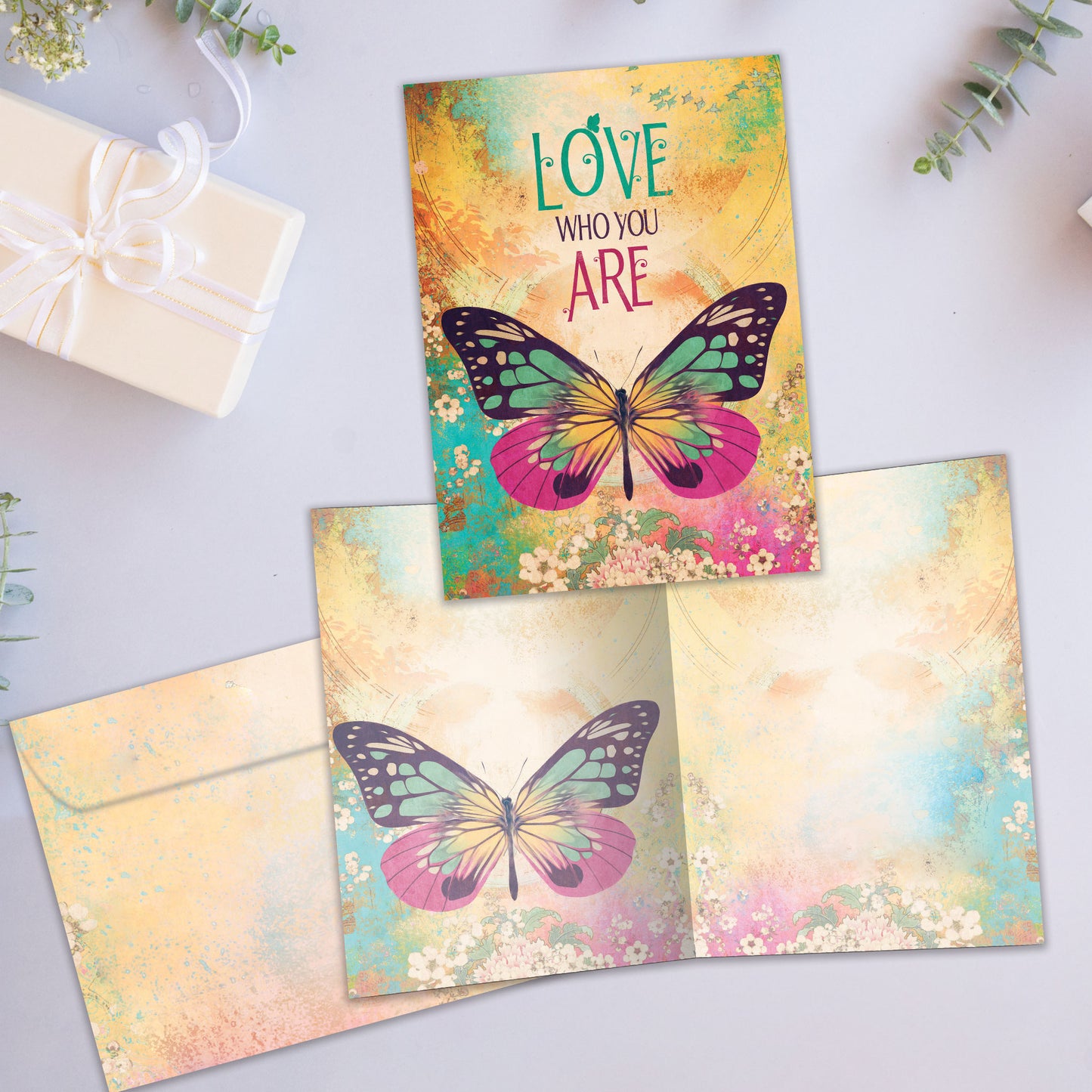 Front and inside view of an All Occasion greeting card showcasing a butterfly illustration with the words 'Love Who You Are,' with a matching envelope.
