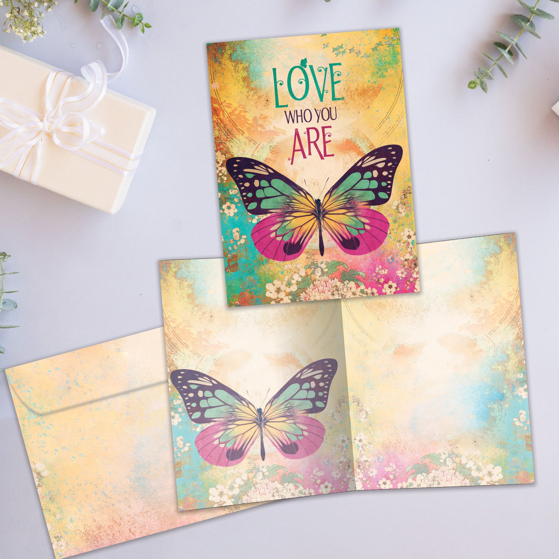 Front and inside view of an All Occasion greeting card showcasing a butterfly illustration with the words 'Love Who You Are,' with a matching envelope.